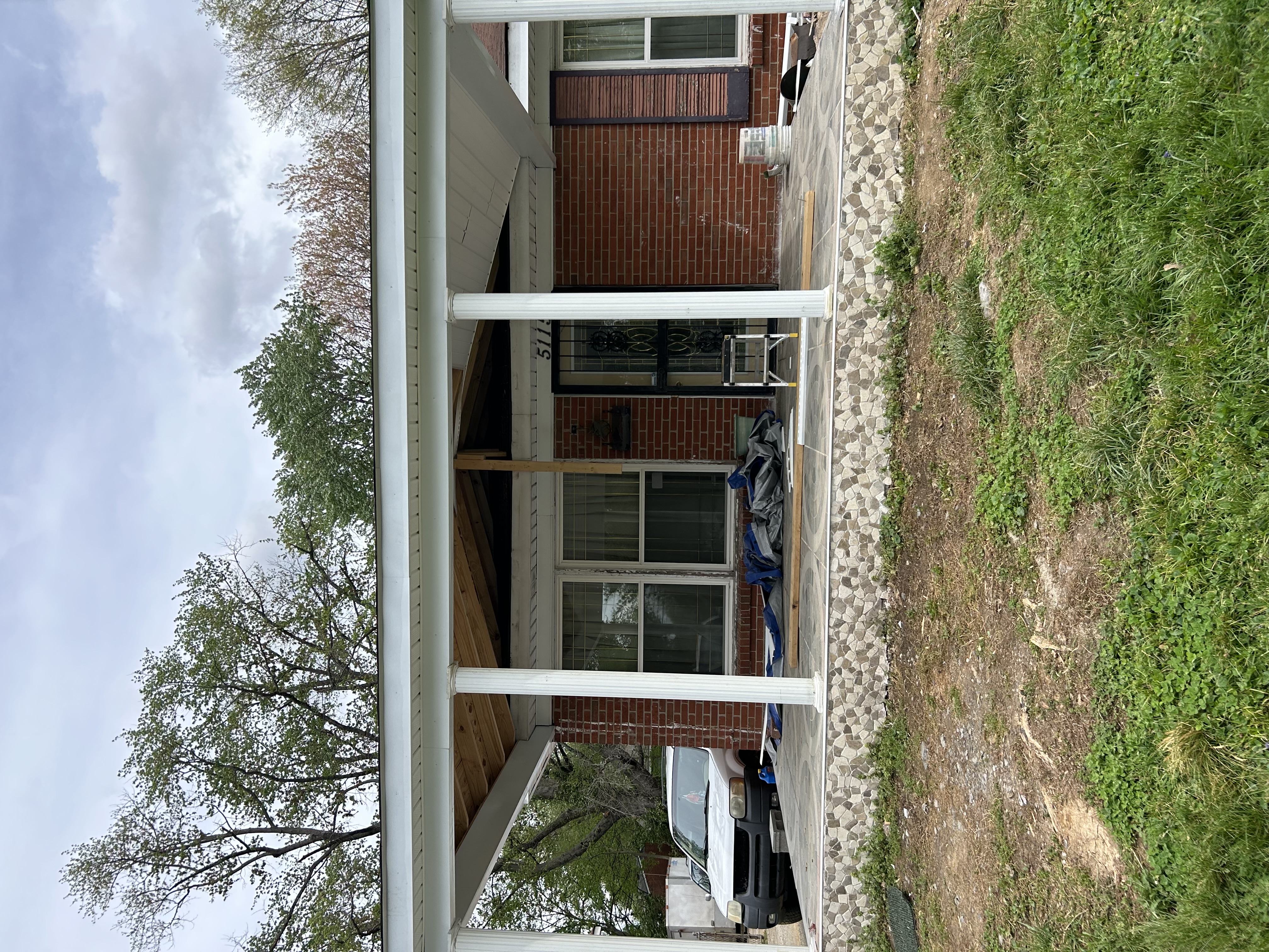 Front porch renovation with new roof framing and stonework